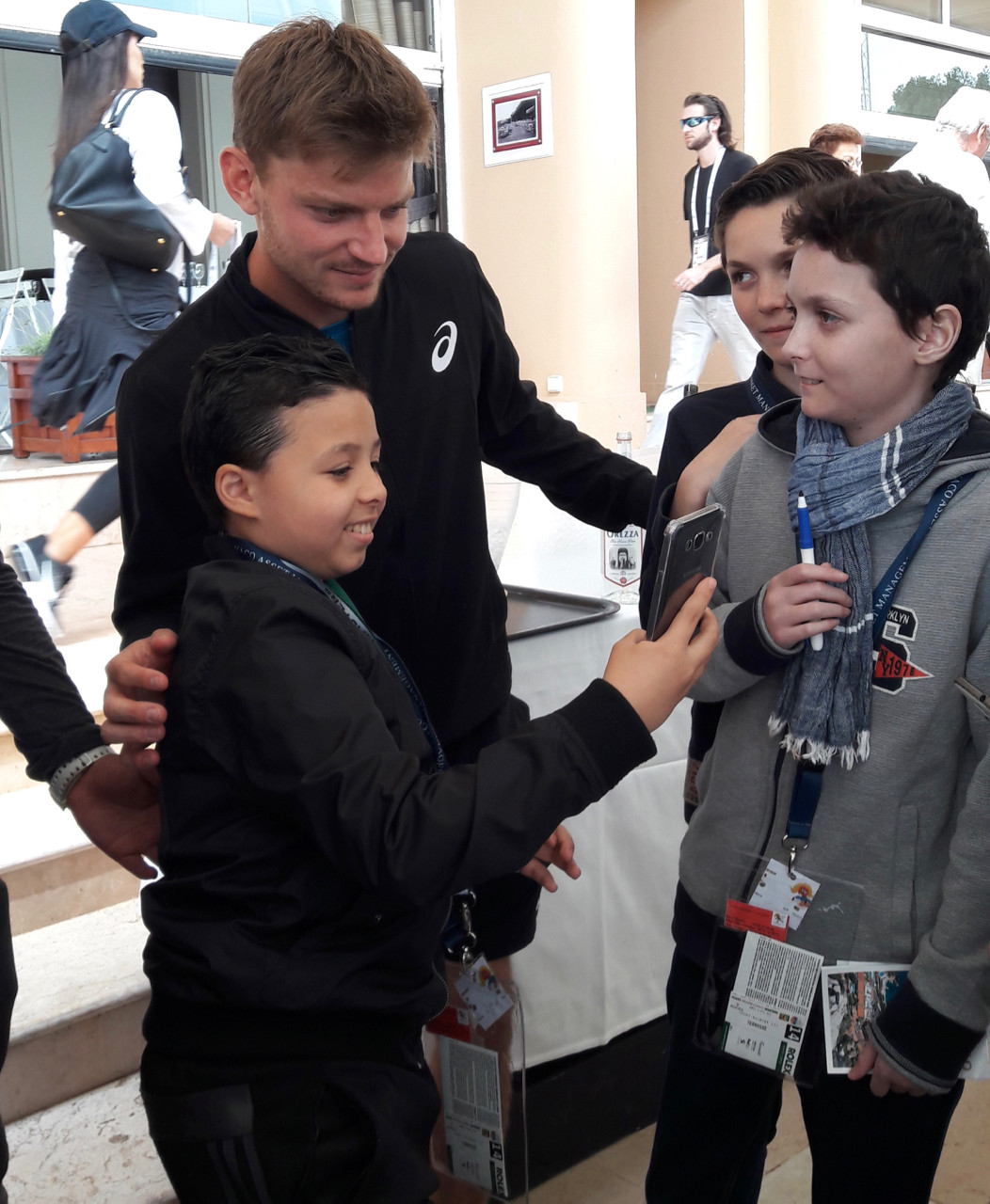 David Goffin poses for selfies with the kids.